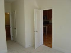 Bedroom looking into bath, closets, living room, kitchen (1313K)